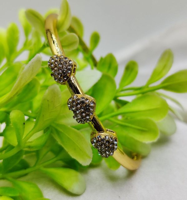 Elegant triple heart bracelet with crystal embellishments and adjustable strap