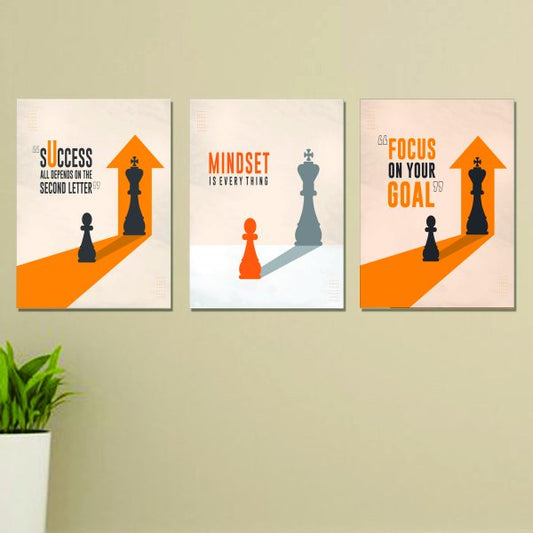 Three motivational posters with chess pieces and text on a wall.